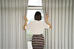 Stylish businesswoman looking out of window