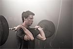 Young man lifting barbell