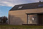 Man looking out of window at home, Tokavaig, Isle of Skye, Scotland