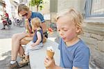 Mother and sons sitting outside eating icecream