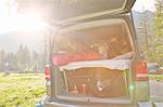 Mother and two sons waking up in camper van, Lake Toblach, Dolomites, South Tyrol, Italy