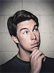 Portrait of young man posing with hand on chin before crossfit training