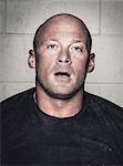 Portrait of bald young man with open mouth after crossfit training