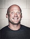 Portrait of smiling bald young man posing before crossfit training