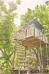 Father and two sons, painting tree house