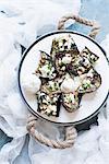 Still life plate of stuffed aubergines with ricotta and herb garnish