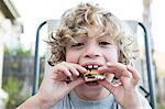 Close up portrait of boy eating a snack