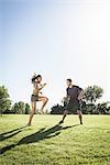 Young woman training with agility ladder in park