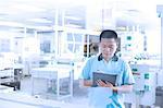 Man working in flexible electronics plant, writing in file