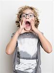 Boy shouting with hands cupping mouth