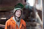Portrait of welder wearing welding mask in shipyard workshop
