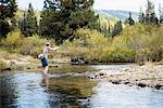 Man in river fly fishing, near Lolo Pass Bitterroot Mountains, Missoula, Montana, USA