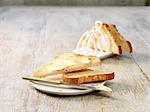 Butter melting on sliced white bread on plate and toast rack