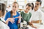 Students listening to teacher in lab