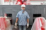 Portrait of male spray painting worker in crane factory, China