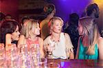 Group of young women chatting in club