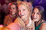 Group of young women taking selfie in club