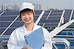 Female worker on roof of solar panel assembly factory, Solar Valley, Dezhou, China
