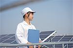 Female worker on roof of solar panel assembly factory, Solar Valley, Dezhou, China