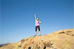 Female runner celebrating on top of hill, Thousand Oaks, California, USA