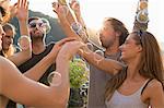 Adult friends partying with floating bubbles on roof terrace