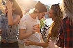 Adult friends dancing at waterfront roof terrace party, Budapest, Hungary