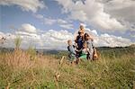 Family walking together through field