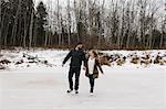 Couple skating on frozen lake, Whitby, Ontario, Canada