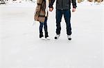 Couple skating on frozen lake, Whitby, Ontario, Canada