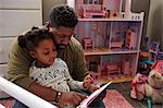 Father reading to daughter
