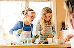 Three surprised girls doing science experiment, staring