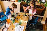 Two girls doing science experiments at messy table