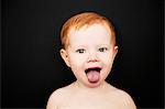 Portrait of toddler sticking his tongue out