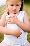 Blond girl holding rabbit figurine