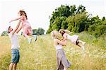 Family playing in meadow