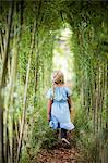 Girl walking in bamboo grove