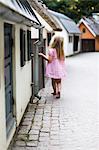 Small girl walking in pink dress