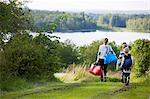 Mother with daughters walking along footpath