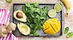 Spinach, avocado and pineapple on baking tray