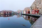 Fishing huts reflecting in water