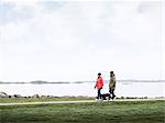 Couple with dog walking at sea