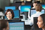 Businesswoman working at computer in open plan office