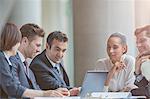 Business people using laptop in conference room meeting