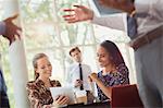 Businesswomen using digital tablet in office meeting