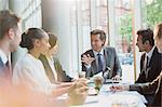 Businessman talking, leading conference room meeting