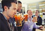 Man drinking beer with friends at bar