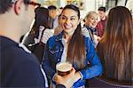 Man and woman drinking beer and talking at bar