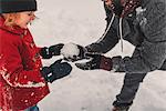 Father and daughter playing in snow