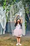 Portrait of young girl, dressed as fairy, dancing outdoors