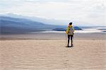 Trekker taking in sights, Death Valley National Park, California, US